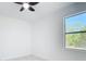 Bright bedroom featuring a large window with natural light, complemented by neutral walls and a ceiling fan at 2639 Sw 162Nd Street Rd, Ocala, FL 34473