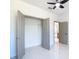 Bright bedroom with a ceiling fan and spacious closet with view into ensuite bathroom at 2639 Sw 162Nd Street Rd, Ocala, FL 34473