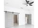 Modern bedroom featuring a sliding barn door and access to a walk-in closet at 2639 Sw 162Nd Street Rd, Ocala, FL 34473