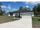 Charming single-story home with a concrete driveway, a two-car garage, and stone accents at 2639 Sw 162Nd Street Rd, Ocala, FL 34473