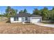 Charming single-story home featuring a well-manicured lawn, a modern door, and an attached garage at 2639 Sw 162Nd Street Rd, Ocala, FL 34473