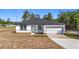 Inviting single-story home boasts a manicured lawn, modern front door, and an attached garage at 2639 Sw 162Nd Street Rd, Ocala, FL 34473