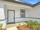 Inviting front porch with a modern door, stylish tiling, and fresh landscaping at 2639 Sw 162Nd Street Rd, Ocala, FL 34473