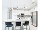 Modern kitchen featuring a center island, stylish pendant lighting, stainless steel appliances, and sleek white cabinetry at 2639 Sw 162Nd Street Rd, Ocala, FL 34473