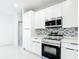 Modern kitchen featuring stainless steel appliances, white cabinets, and stylish backsplash at 2639 Sw 162Nd Street Rd, Ocala, FL 34473