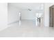 Spacious, open-concept living area with sleek floors, modern lighting, and a partial view of kitchen at 2639 Sw 162Nd Street Rd, Ocala, FL 34473
