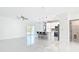 Open-concept living area with sleek floors, island seating, and abundant natural light from sliding glass doors at 2639 Sw 162Nd Street Rd, Ocala, FL 34473