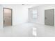 Bright, open living space with tile floors and a view of the laundry room and the garage entry at 2639 Sw 162Nd Street Rd, Ocala, FL 34473