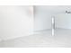 Bright, open living room with pristine white walls, modern tile flooring, and a ceiling fan for added comfort at 2639 Sw 162Nd Street Rd, Ocala, FL 34473