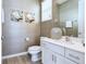 Stylish bathroom with modern fixtures, a vanity with a white countertop, and decorative wall art at 2649 Calistoga Ave, Kissimmee, FL 34741