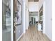Bright entryway featuring unique console table and decor; gray accent wall and light wood-look flooring at 2649 Calistoga Ave, Kissimmee, FL 34741