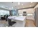 Bright kitchen with stainless appliances, white cabinetry, and a large center island at 2649 Calistoga Ave, Kissimmee, FL 34741