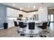 Modern kitchen featuring a center island with seating, white cabinets, and stainless appliances at 2649 Calistoga Ave, Kissimmee, FL 34741