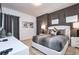 Stylish primary bedroom featuring a bed, patterned wallpaper, and two large windows at 2649 Calistoga Ave, Kissimmee, FL 34741