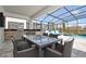 Outdoor dining area featuring a screened-in patio with a table, chairs, and outdoor kitchen at 2649 Calistoga Ave, Kissimmee, FL 34741