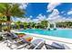 Resort-style pool with lounge chairs and palm trees offering a relaxing oasis under a sunny sky at 2649 Calistoga Ave, Kissimmee, FL 34741