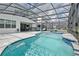 Enclosed pool with a spa, waterfall feature, and a view of the outdoor living space at 2649 Calistoga Ave, Kissimmee, FL 34741
