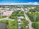 Bird's eye view of the property and neighborhood with mature trees and lake nearby at 302 E Drury Ave, Kissimmee, FL 34744