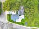 Aerial view of the home with lush trees surrounding the area at 302 E Drury Ave, Kissimmee, FL 34744