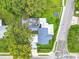 Aerial view of the home with lush trees surrounding the area at 302 E Drury Ave, Kissimmee, FL 34744