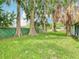 Lush backyard with trees providing ample shade, showcasing the property's outdoor space at 302 E Drury Ave, Kissimmee, FL 34744