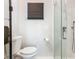 Bright bathroom featuring a modern toilet and textured shower with sleek glass door at 302 E Drury Ave, Kissimmee, FL 34744