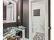 Contemporary bathroom features a sleek glass sink, black walls and a stylish toilet at 302 E Drury Ave, Kissimmee, FL 34744