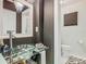 Stylish bathroom featuring a glass vessel sink and a bright, minimalist toilet area at 302 E Drury Ave, Kissimmee, FL 34744