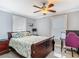 Bedroom with neutral walls, complemented by a fan and desk area with chair at 302 E Drury Ave, Kissimmee, FL 34744