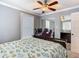 Bedroom with neutral paint and fan, features a closet and a desk area at 302 E Drury Ave, Kissimmee, FL 34744