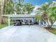 Driveway with covered carport and parking for two cars or a car and boat at 302 E Drury Ave, Kissimmee, FL 34744