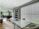 Bright dining room with glass-top table and backyard views, connecting to other living areas at 302 E Drury Ave, Kissimmee, FL 34744