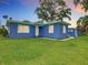 Charming exterior view of home, showing the front lawn and details at 302 E Drury Ave, Kissimmee, FL 34744
