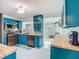 Kitchen with vibrant blue cabinets, butcher block countertops and stainless steel appliances at 302 E Drury Ave, Kissimmee, FL 34744