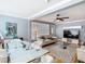 An expansive living room featuring a glass table, modern furniture, and light blue walls at 302 E Drury Ave, Kissimmee, FL 34744