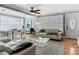 Bright living room featuring hardwood floors, a zebra-print rug, modern furniture, and natural light at 302 E Drury Ave, Kissimmee, FL 34744