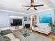 Comfortable living room with sleek furniture, hardwood floors, ceiling fan and ample decor at 302 E Drury Ave, Kissimmee, FL 34744