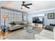 Comfortable living room with sleek furniture, hardwood floors, ceiling fan and large window at 302 E Drury Ave, Kissimmee, FL 34744