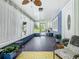 Enclosed porch featuring light-filled windows, plants, and decorative ceiling fan at 302 E Drury Ave, Kissimmee, FL 34744