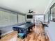 A recreation room featuring hardwood floors, an entertainment center, and a pool table for entertainment at 302 E Drury Ave, Kissimmee, FL 34744