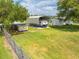 Large, fenced property with a large metal RV cover, shed, and plenty of space for outdoor activities at 3048 Cherokee Rd, St Cloud, FL 34772