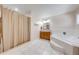 Bathroom featuring a tub, wood vanity, and a shower with beige curtain and neutral tones at 3048 Cherokee Rd, St Cloud, FL 34772