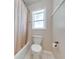 Bright bathroom featuring a shower/tub combination and a toilet at 3048 Cherokee Rd, St Cloud, FL 34772
