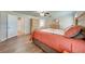 A spacious bedroom features warm wood flooring and neutral wall color at 3048 Cherokee Rd, St Cloud, FL 34772