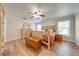 A cozy bedroom featuring warm wood flooring, a ceiling fan and two windows at 3048 Cherokee Rd, St Cloud, FL 34772