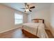 Inviting bedroom with a ceiling fan, a window view, and hardwood floors at 3048 Cherokee Rd, St Cloud, FL 34772
