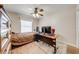 Cozy bedroom with a ceiling fan, a desk, and a window at 3048 Cherokee Rd, St Cloud, FL 34772