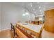 Bright dining room featuring hardwood floors, ample seating, and modern pendant lights at 3048 Cherokee Rd, St Cloud, FL 34772