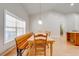 Light-filled dining room with bench seating, modern pendant lighting, and hardwood floors at 3048 Cherokee Rd, St Cloud, FL 34772