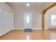 Bright foyer featuring a white front door, spacious closet, and beautiful wood-look flooring at 3048 Cherokee Rd, St Cloud, FL 34772